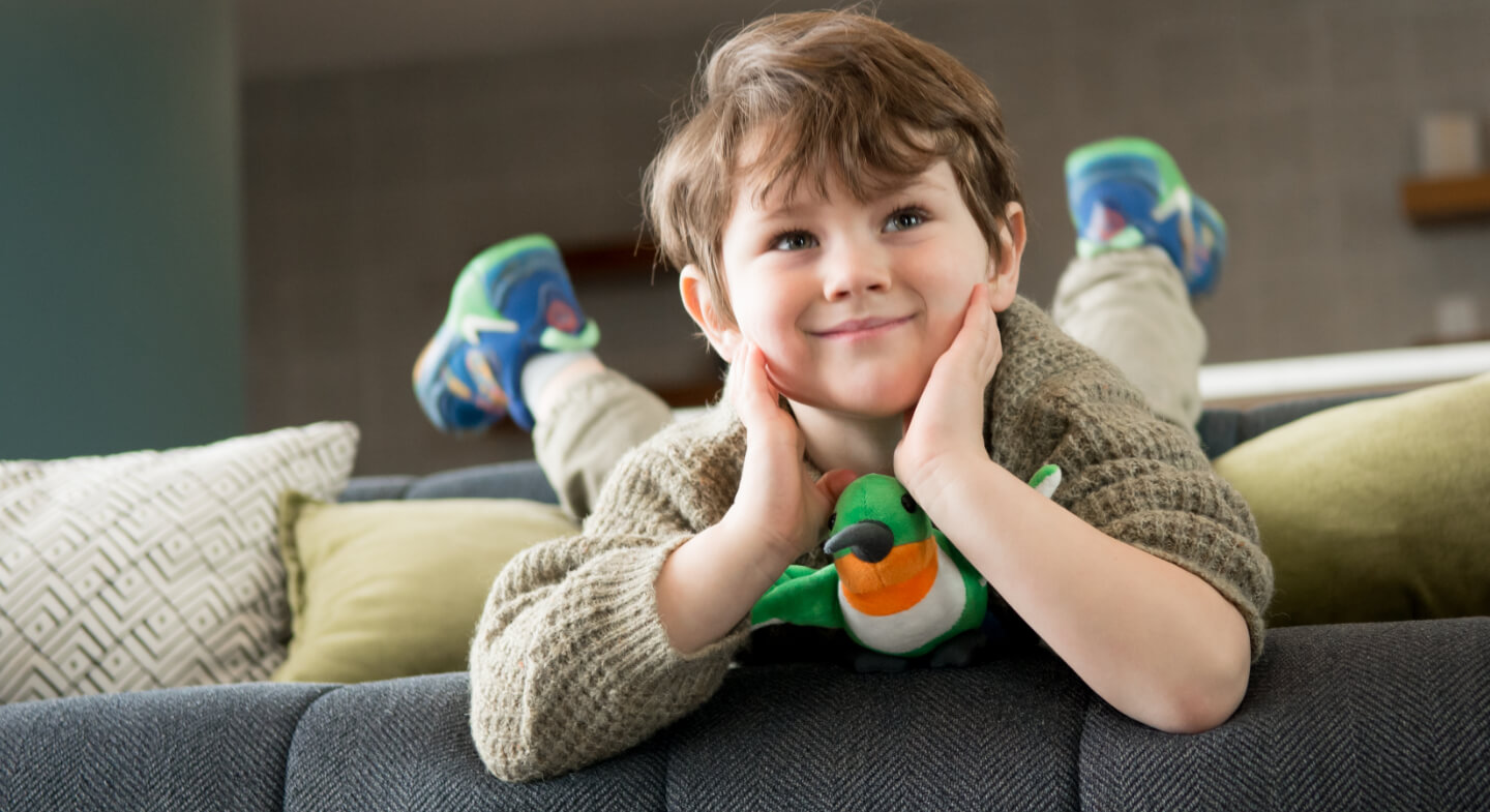 child with stuffed hummingbird toy